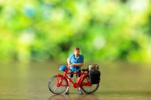 miniatura personas en pie con bicicleta, mundo bicicleta día concepto foto