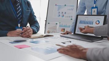 Financial analysts analyze business financial reports on a digital tablet planning investment project during a discussion at a meeting of corporate showing the results of their successful teamwork. video