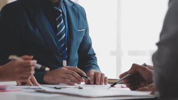 Financial analysts analyze business financial reports on a digital tablet planning investment project during a discussion at a meeting of corporate showing the results of their successful teamwork. video