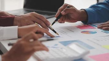Financial analysts analyze business financial reports on a digital tablet planning investment project during a discussion at a meeting of corporate showing the results of their successful teamwork. video