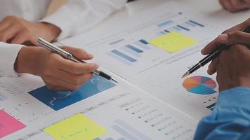 Financial analysts analyze business financial reports on a digital tablet planning investment project during a discussion at a meeting of corporate showing the results of their successful teamwork. video