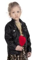 Little girl model. Sad child with a red heart. Beautiful five year old baby. photo