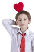 Child with Valentine. Smart boy holds a heart. photo