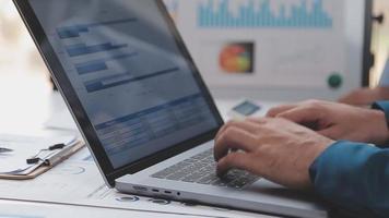 Financial analysts analyze business financial reports on a digital tablet planning investment project during a discussion at a meeting of corporate showing the results of their successful teamwork. video