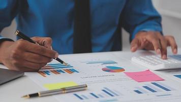 Financial analysts analyze business financial reports on a digital tablet planning investment project during a discussion at a meeting of corporate showing the results of their successful teamwork. video