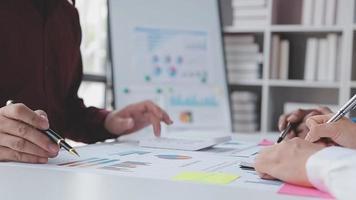 Financial analysts analyze business financial reports on a digital tablet planning investment project during a discussion at a meeting of corporate showing the results of their successful teamwork. video