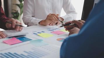 Financial analysts analyze business financial reports on a digital tablet planning investment project during a discussion at a meeting of corporate showing the results of their successful teamwork. video