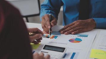 Financial analysts analyze business financial reports on a digital tablet planning investment project during a discussion at a meeting of corporate showing the results of their successful teamwork. video
