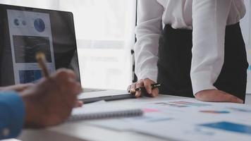 Financial analysts analyze business financial reports on a digital tablet planning investment project during a discussion at a meeting of corporate showing the results of their successful teamwork. video