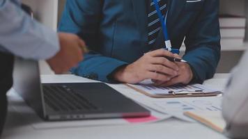 Financial analysts analyze business financial reports on a digital tablet planning investment project during a discussion at a meeting of corporate showing the results of their successful teamwork. video