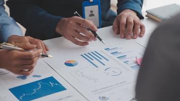 Financial analysts analyze business financial reports on a digital tablet planning investment project during a discussion at a meeting of corporate showing the results of their successful teamwork. video