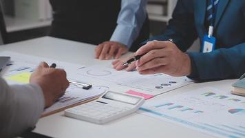 Financial analysts analyze business financial reports on a digital tablet planning investment project during a discussion at a meeting of corporate showing the results of their successful teamwork. video