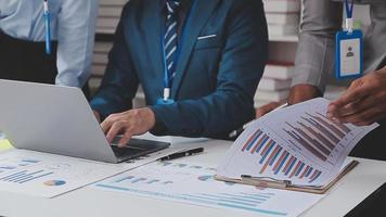 Financial analysts analyze business financial reports on a digital tablet planning investment project during a discussion at a meeting of corporate showing the results of their successful teamwork. video