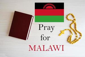 Pray for Malawi. Rosary and Holy Bible background. photo