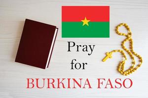 Pray for Burkina Faso. Rosary and Holy Bible background. photo