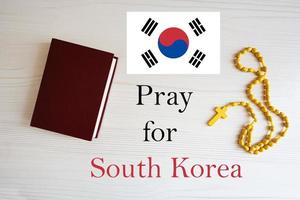 Pray for South Korea. Rosary and Holy Bible background. photo