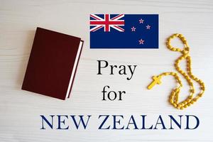 Pray for New Zealand. Rosary and Holy Bible background. photo