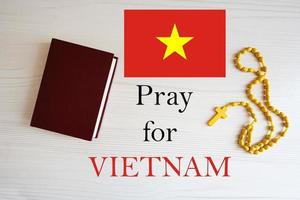 Pray for Vietnam. Rosary and Holy Bible background. photo