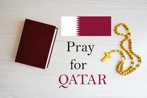 Pray for Qatar. Rosary and Holy Bible background. photo