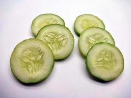 Slices of cucumbers isolated in white background photo