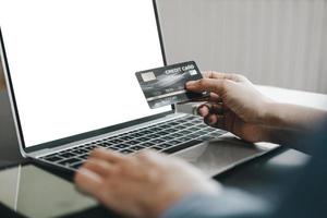 Mockup image of Beautiful woman holding credit card shopping online with laptop on online websites, mockup concept photo