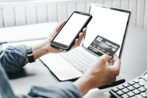 Mockup image of beautiful woman holding credit card enjoying in shopping website online with smartphone and laptop, mockup concept photo