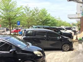 batam,indonesia-maret 2023, full car park on the side of the road photo