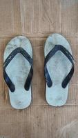 dirty white flip-flops after being used from activities photo