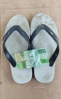 Money two thousand rupiah and white flip-flops after being used from activities photo