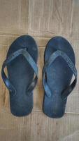 dirty black flip-flops after being used from activities photo