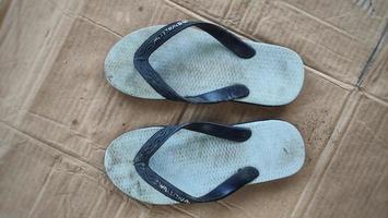 dirty white flip-flops after being used from activities photo