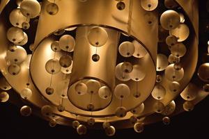 an  abstract background with an original glowing chandelier on the ceiling photo