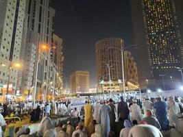 Mecca, Saudi Arabia, April 2023 - A beautiful view of pilgrims, tall buildings and lights at night on the outer road in Masjid al-Haram, Mecca. photo