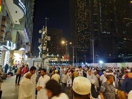 Mecca, Saudi Arabia, April 2023 - A large number of pilgrims from all over the world gather on the outer road near Masjid al-Haram, Mecca at night. photo