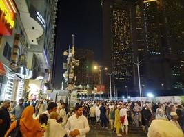 Mecca, Saudi Arabia, April 2023 - A large number of pilgrims from all over the world gather on the outer road near Masjid al-Haram, Mecca at night. photo