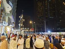 Mecca, Saudi Arabia, April 2023 - A large number of pilgrims from all over the world gather on the outer road near Masjid al-Haram, Mecca at night. photo