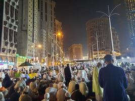 Mecca, Saudi Arabia, April 2023 - A beautiful view of pilgrims, tall buildings and lights at night on the outer road in Masjid al-Haram, Mecca. photo