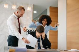 Team thinking of problem solution at office meeting, sad diverse business people group shocked by bad news, upset colleagues in panic after company bankruptcy concept photo