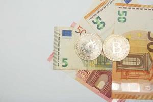 euro y bitcoin billetes de banco, criptomoneda y blockchain concepto en blanco antecedentes plano laico foto