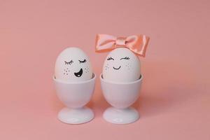 eggs with face and flowers on the pink bow, for Easter background photo