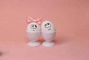 eggs with face and flowers on the pink bow, for Easter background photo