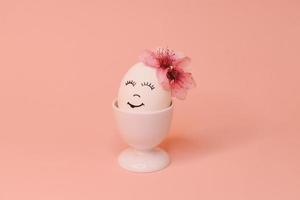 eggs with face and flowers on the pink bow, for Easter background photo