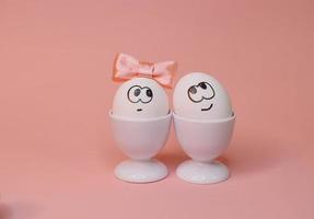 eggs with face and flowers on the pink bow, for Easter background photo