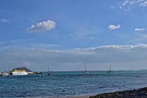 oceanic calm landscape on the Spanish island of Fuerteventura with boats photo