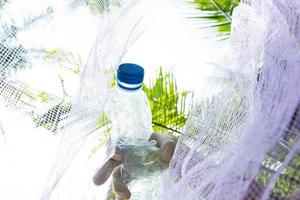 People put plastic bottles in garbage bags. agriculture and climate change, micro plastic waste. food and plastic packaging industry photo