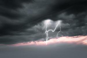 Lightning thunderstorm flash over the night sky. Concept on topic weather, cataclysms photo