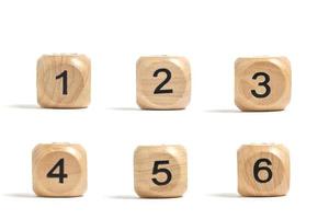 Six wooden cubes with numbers for board games white background. photo