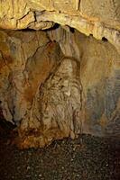 interesting original cave in the Turkish mountains with stalactites and stalagmites creating the background photo