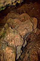 interesting original cave in the Turkish mountains with stalactites and stalagmites creating the background photo