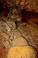 interesting original cave in the Turkish mountains with stalactites and stalagmites creating the background photo